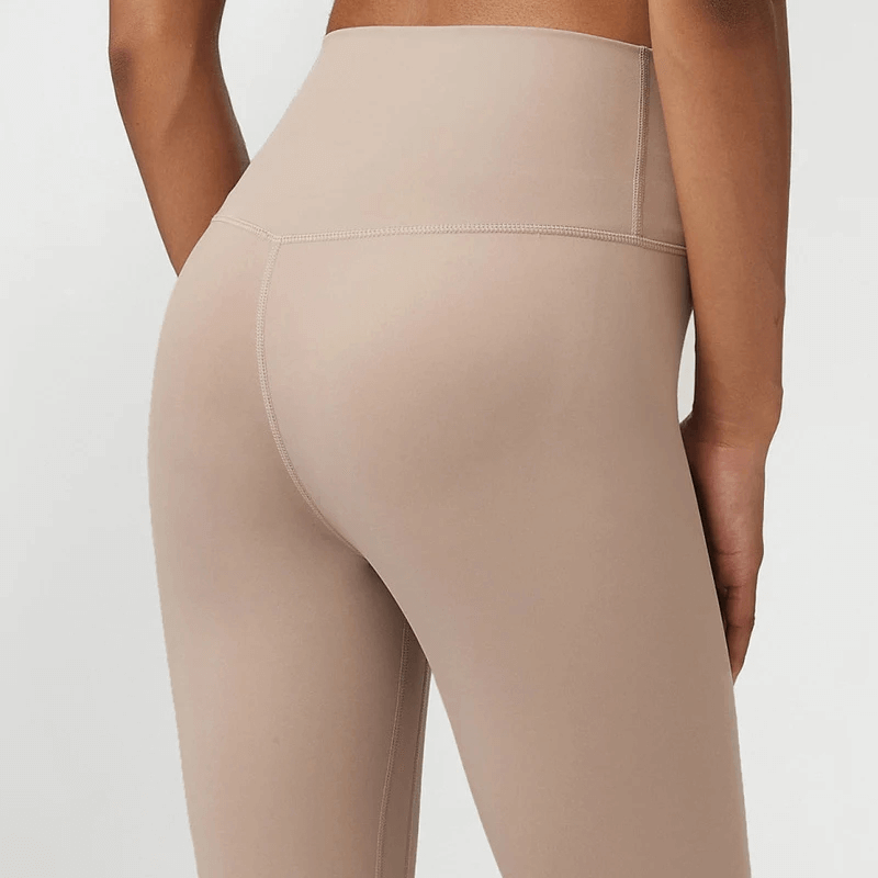 Back view of stylish high-waist beige women's yoga leggings, designed for optimal fit and comfort, perfect for workouts or casual wear.
